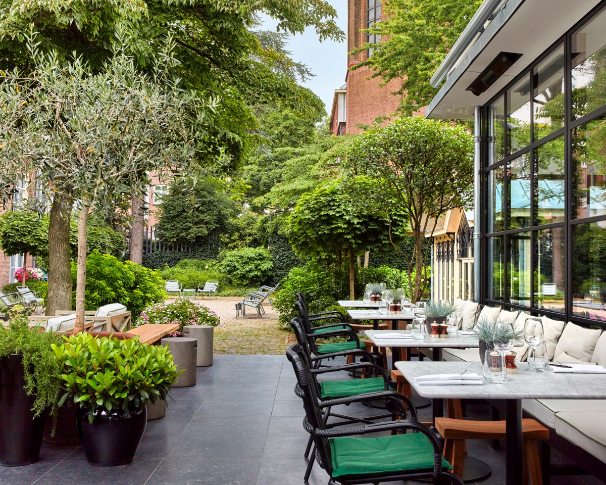 A view of the hotel restaurant showcasing neatly set tables and chairs, inviting guests to enjoy their meals.